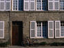 Bike leaning against granite stone house.