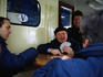 Playing cards on the public boat going to islands of the lagoon.