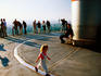 Child waking atop Observation Deck of Main Tower with sightseers in background.