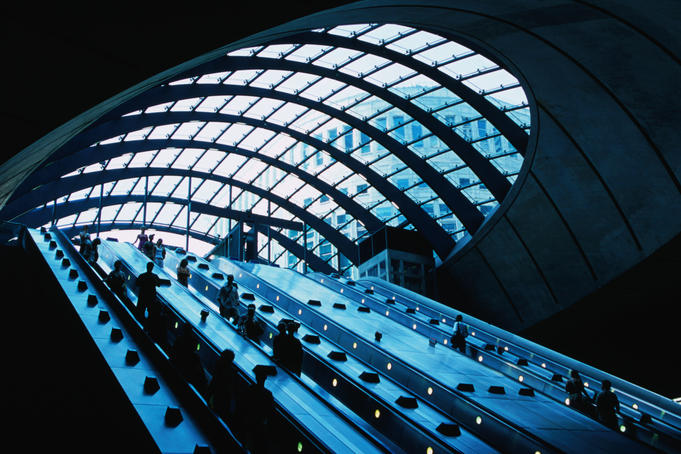 Escalators and glassed in roof at Canary Wharf Underground Station.