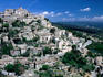 Provence. Tiered Vaucluse village of Gordes sits on a white rocky hill.