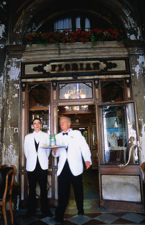 Waiter and doorman at door of Caffe Florian on Saint Marks Square (Piazza San Marco).