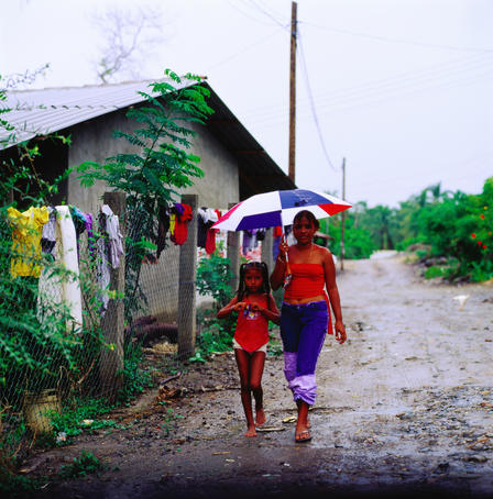 Young girls walking in rain, Troncones.