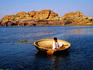 Man paddling coracle on Tungabhadra River.