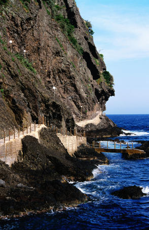Coastal path at foot of cliff.