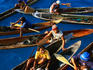 Vendors selling art and crafts from dug-out canoes.