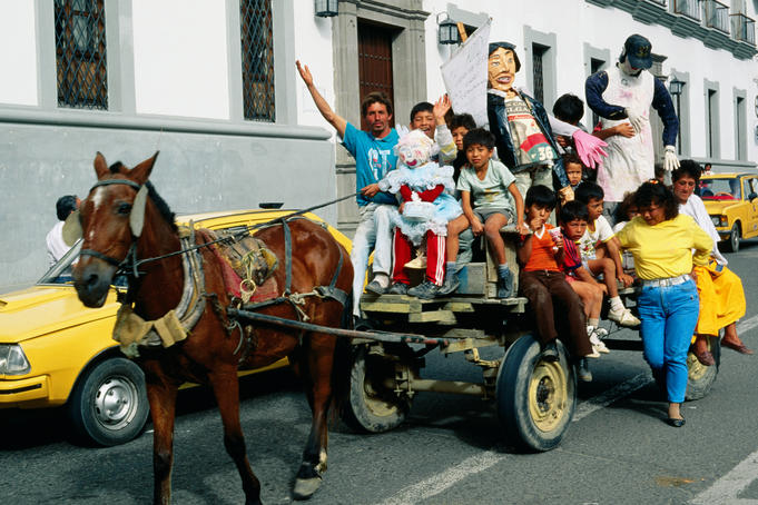 Crowds in the street in a horse and cart as part of the New Year celebrations - Popayan, Cauca