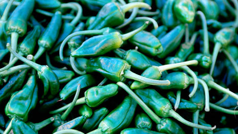 Detail of green chillies at market.