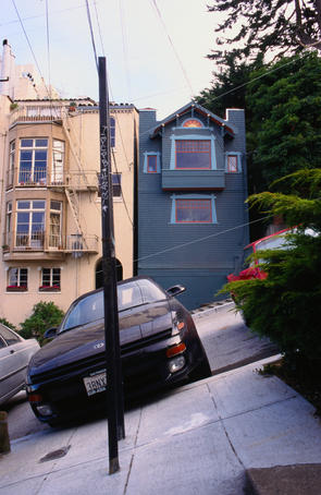 Cars and houses on an angle on sloping Filbert Street.
