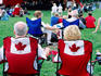 Spectators in maple-leaf chairs at jazz festival in Confederation Park