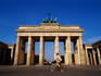 Man cycling past Brandenburger Tor.