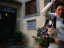 Woman carrying cat outside Hotel Boticelli.