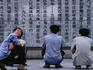Men reading script at the Monumnet of the People's Hero at Huangou Park.