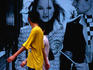 People in front of fashion poster.