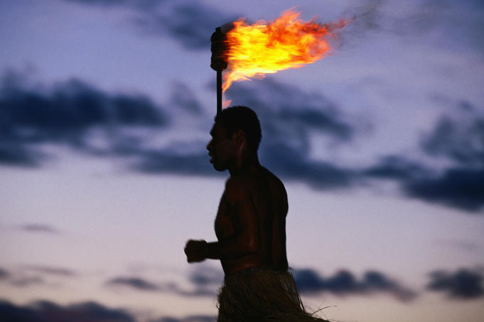 Islander with flaming torch.