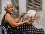 Female street barber at work.