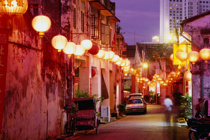 Narrow street in Chinatown decorated with lanterns.