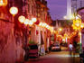 Narrow street in Chinatown decorated with lanterns.