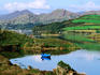 Blue boat on tranquil Kenmare River.