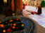 Buddhist prostrates in front of Mahabodhi Temple with Buddha footprints in foreground.