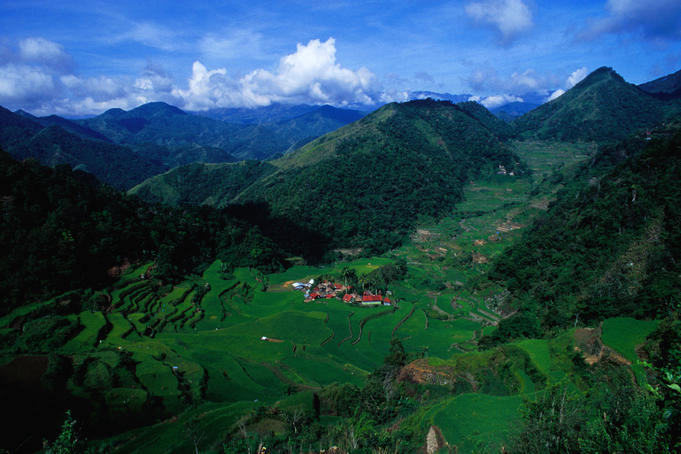 Village set amid rice terraces and mountains.