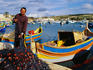 Fisherman with net at harbour.