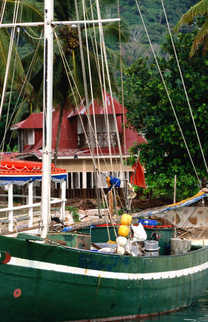 Boat docked beside pier.