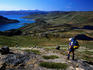Overhead of hiker taking in view above a fjord between Kangerlussuaq and Sisimiut, Arctic Circle Trek.