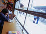 Man reading French newspaper at Marche Jean Talon.