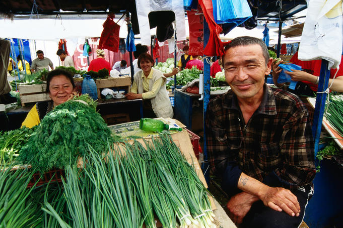 Man selling spring onions in Green Bazar.