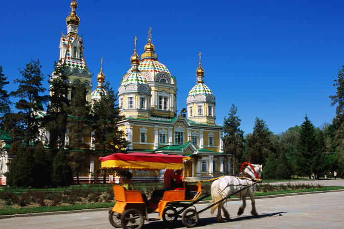 Horse with cart in front of tsarist-era wooden Russian Orthodox church.