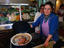 Woman showing Curanto stew at Angelmo fish market.
