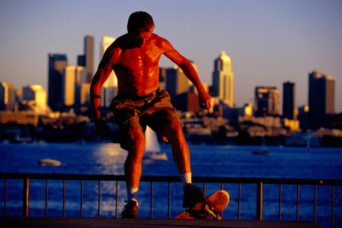 Skateboarder with city skyline in background, Gasworks Park, Fremont.
