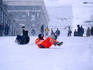 Sliding in the snow on the street.