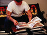 Man choosing a tattoo at the Mind's Eye Tattoo parlour.