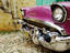 1957 Chevy Bel-Air car front grill and bumper in cobbled street.