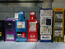 Newspaper boxes lined up on street.