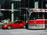 Taxi and street car waiting at lights.