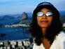 Woman on Corcovado with Guanabara Bay in background.