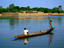 Two boys poling a pirogue (dugout), Niger River.