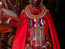 Maasai woman in front of craft shop.