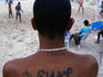 Boy with tatoo on back that reads 