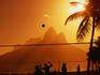 People playing volleyball on Ipanema beach at sunset.