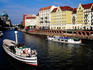 Tourist boats on Spree River with Berlin Cathedral in background.