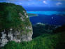 Aerial view of mountains and bay near Tipoto, with Renaissance cruise ship in distance.