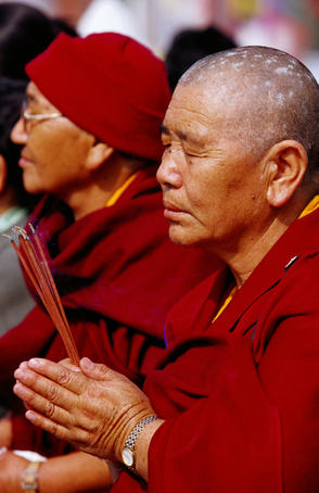 Nun praying during Losar (Tibetan New Year) celebrations at Bodhnath Stupa.