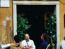 People sitting at bar on Vicolo del Cinque in Trastevere.