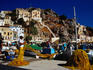 Fisherman tending to his nets after a days fishing - Symi, Symi Island, Dodecanese