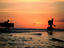 Surfers walk through river, trekking from Avellanas to Tamarindo.