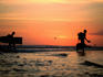 Surfers walk through river, trekking from Avellanas to Tamarindo.